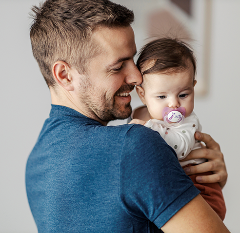 Man holding baby in a room