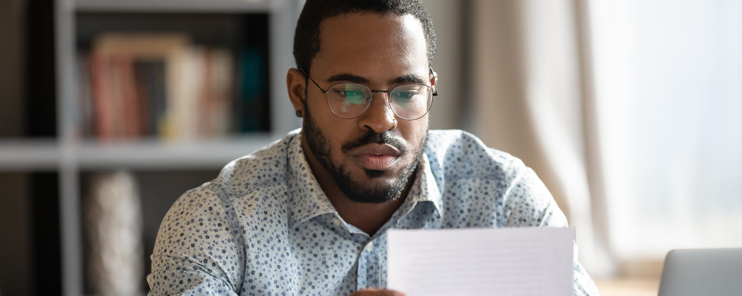 Man looking at piece of paper
